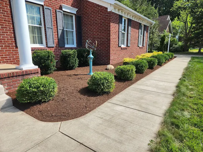Fresh mulch and trimmed shrubs at an Erie brick home