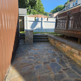 Flagstone patio with stone retaining wall